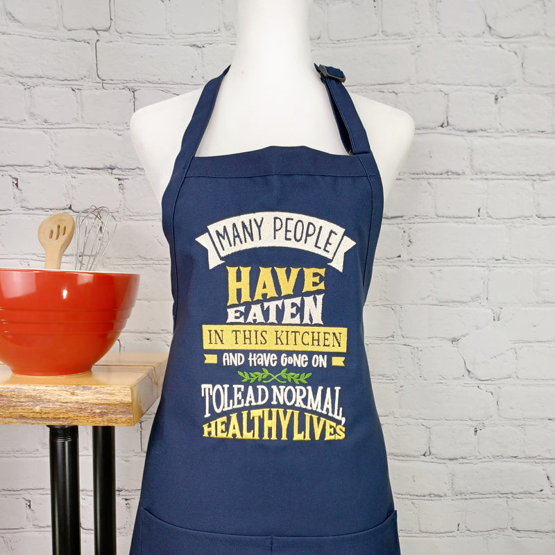 Funny apron Life is what you bake it embroidered kitchen accessory with pockets and adjustable neck multiple lengths great hostess gift