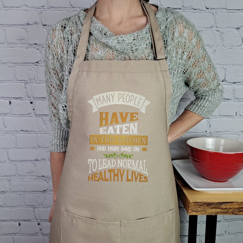 Funny apron Life is what you bake it embroidered kitchen accessory with pockets and adjustable neck multiple lengths great hostess gift